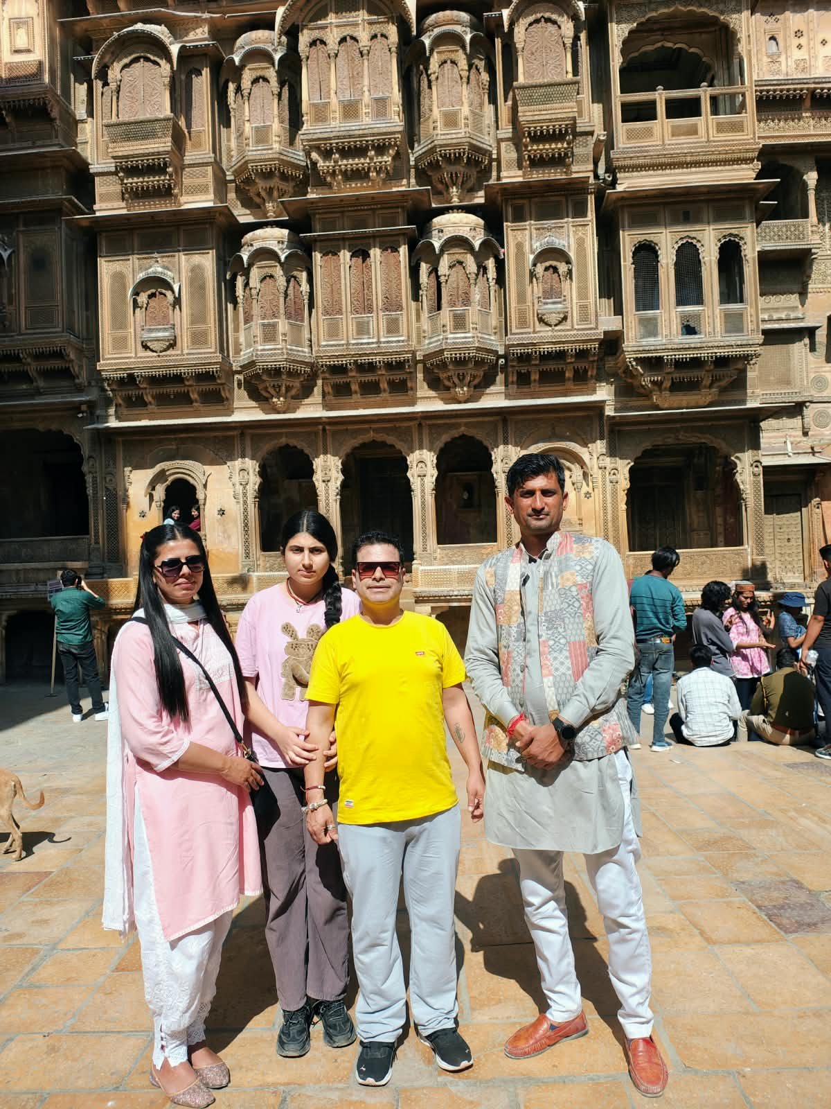 Saim with a family at Patwa Haveli
